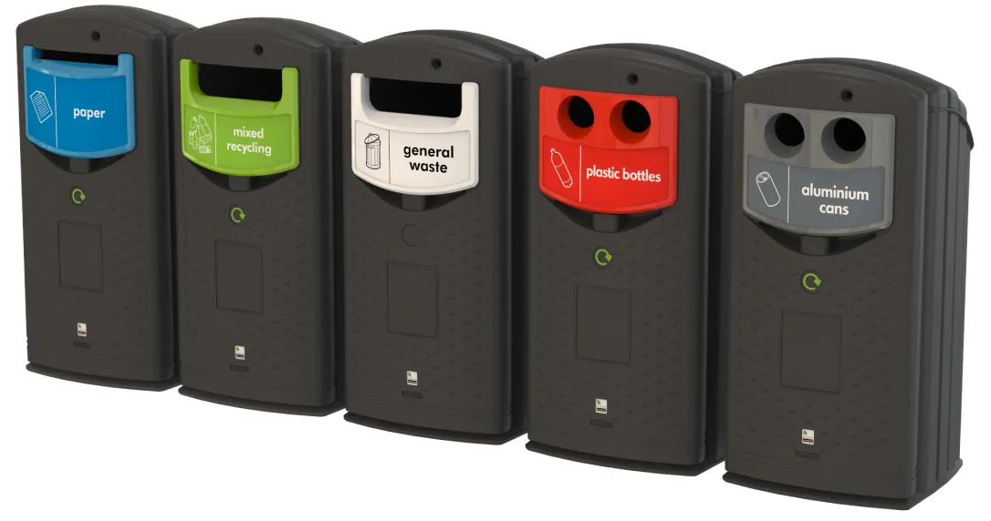 A row of Envirobank recycling bins for paper, mixed recycling, general waste, plastic bottles and cans